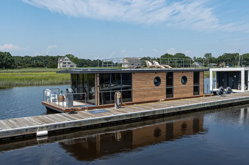 Slide: The Image of Modern Waterlodge Apart XXL houseboat docked on a serene river, 2025 model. - 37