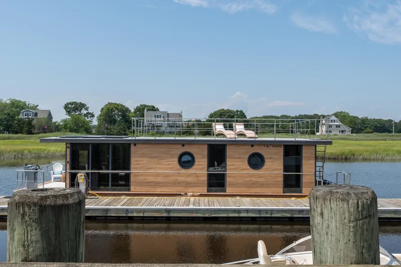 Slide: The Image of Modern Waterlodge Apart XXL houseboat docked, featuring sleek design and rooftop seating, 2025 model. - 38