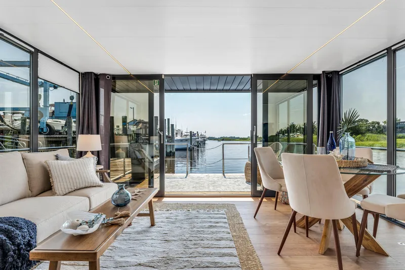 Slide: The Image of Modern Waterlodge Apart XXL 2025 interior with elegant decor, large windows, and waterfront view. - 4