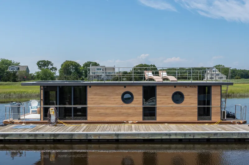Slide: The Image of Modern Waterlodge Apart XXL houseboat docked on a serene river, 2025 model. - 40