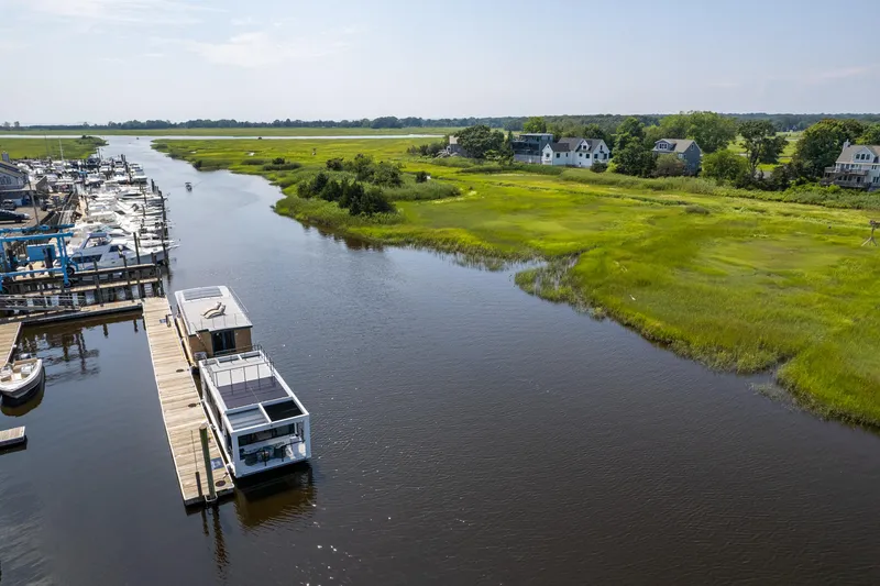 Slide: The Image of Houseboat Waterlodge Apart XXL 2025 docked on serene river with lush green landscape. - 45