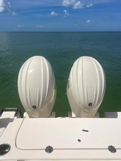 Slide: The Image of 2024 Grady-White Freedom 275 boat with twin outboard motors on calm sea. - 3