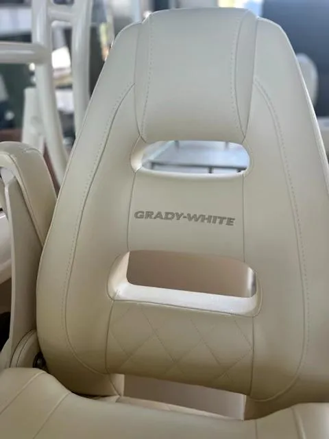Slide: The Image of 2024 Grady-White Freedom 275 boat seat, beige leather, close-up view. - 5