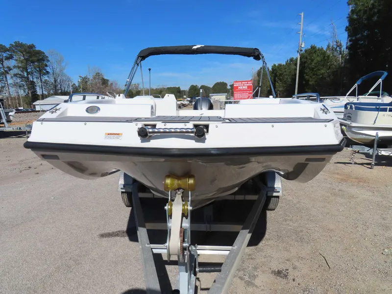 Slide: The Image of 2022 Starcraft SVX 171 boat on trailer, parked outdoors under clear blue sky. - 22