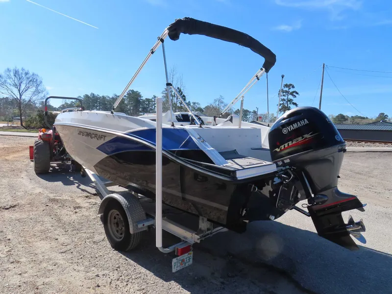Slide: The Image of 2022 Starcraft SVX 171 boat with Yamaha engine on trailer, parked outdoors. - 24