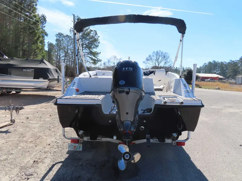 Slide: The Image of 2022 Starcraft SVX 171 boat with outboard motor, parked outdoors on a sunny day. - 25