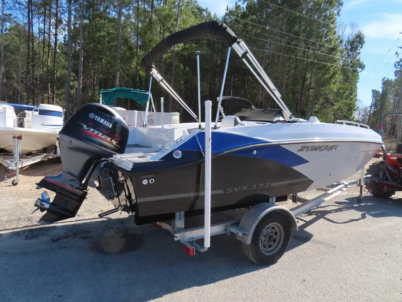 Slide: The Image of 2022 Starcraft SVX 171 boat on trailer with Yamaha outboard motor, parked outdoors. - 26