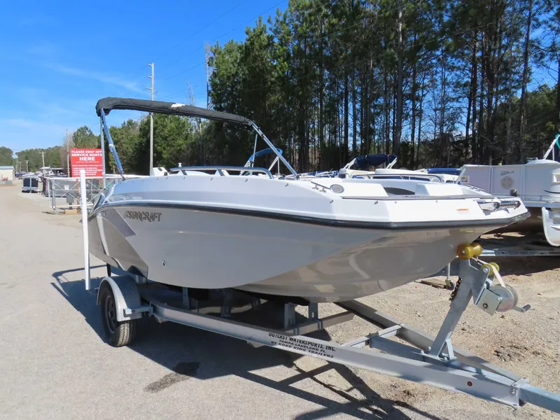 Slide: The Image of 2022 Starcraft SVX 171 boat on trailer, parked outdoors near trees. - 28
