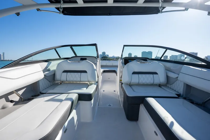 Slide: The Image of 2022 Regal LX2 boat interior with luxurious seating and city skyline view. - 11