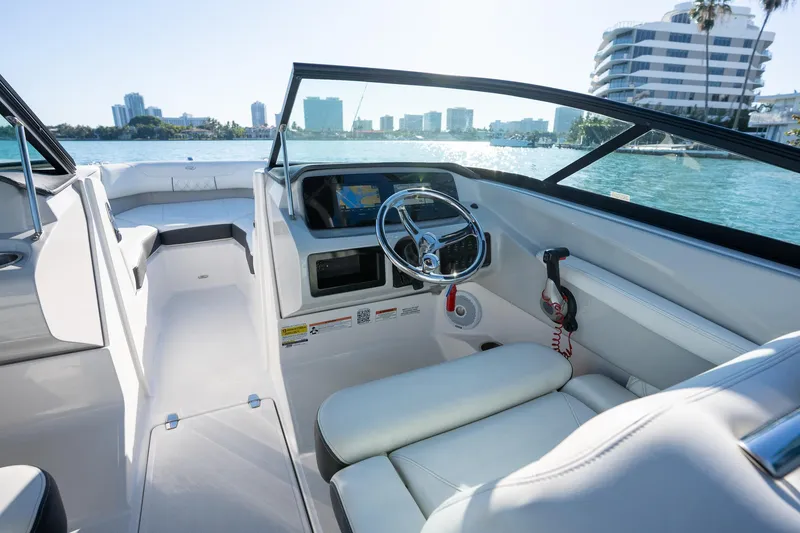 Slide: The Image of 2022 Regal LX2 boat interior with modern dashboard and waterfront view. - 12