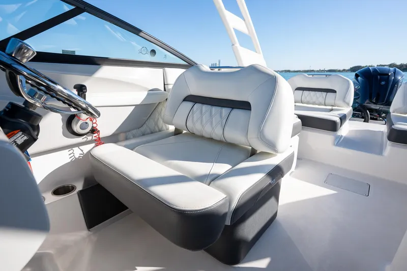 Slide: The Image of 2022 Regal LX2 boat interior with luxurious seating and steering wheel. - 17