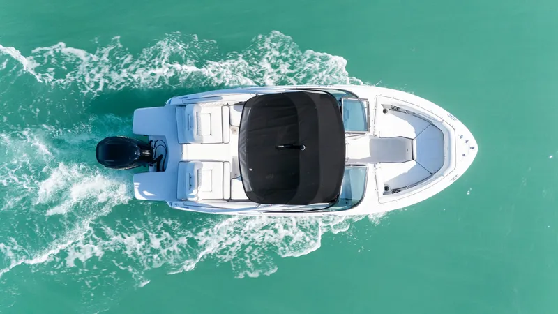 Slide: The Image of 2022 Regal LX2 boat cruising on turquoise water, aerial view. - 22