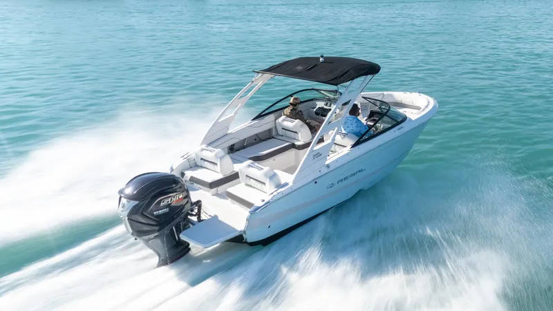 Slide: The Image of 2022 Regal LX2 boat cruising on clear blue water, featuring a sleek design and powerful engine. - 3