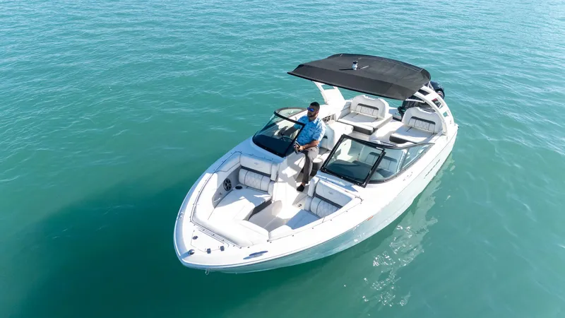 Slide: The Image of 2022 Regal LX2 boat on clear blue water, featuring sleek design and spacious seating. - 4