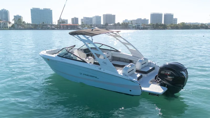 Slide: The Image of 2022 Regal LX2 boat on water with city skyline in background. - 5