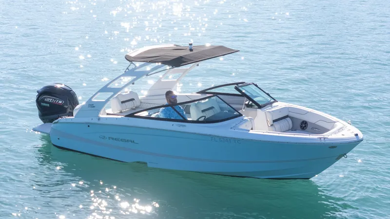 Slide: The Image of 2022 Regal LX2 boat on clear blue water, featuring sleek design and Yamaha outboard motor. - 7