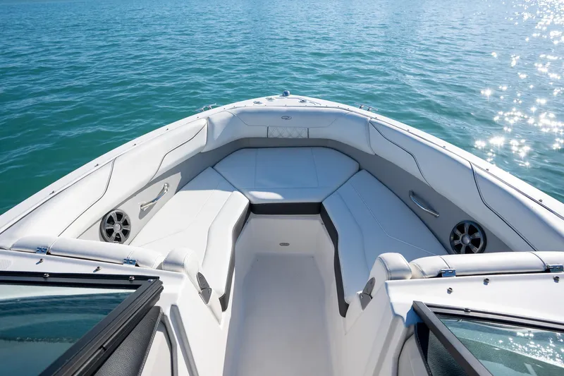 Slide: The Image of 2022 Regal LX2 boat interior with white seating on calm blue water. - 8