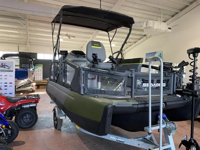 Slide: The Image of 2025 Sea-Doo Switch Fish 18 boat displayed indoors on a trailer. - 12
