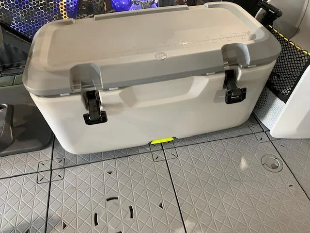 Slide: The Image of Cooler on 2025 Sea-Doo Switch Fish 18 boat deck, featuring secure latches and textured flooring. - 3