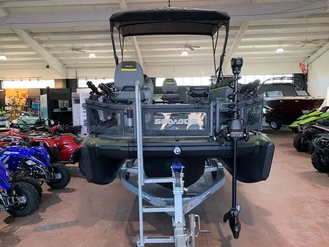 Slide: The Image of 2025 Sea-Doo Switch Fish 18 pontoon boat in showroom, front view. - 10