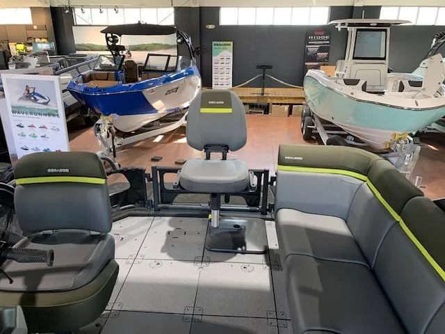 Slide: The Image of 2025 Sea-Doo Switch Fish 18 interior with seating, displayed in a showroom with other boats. - 6