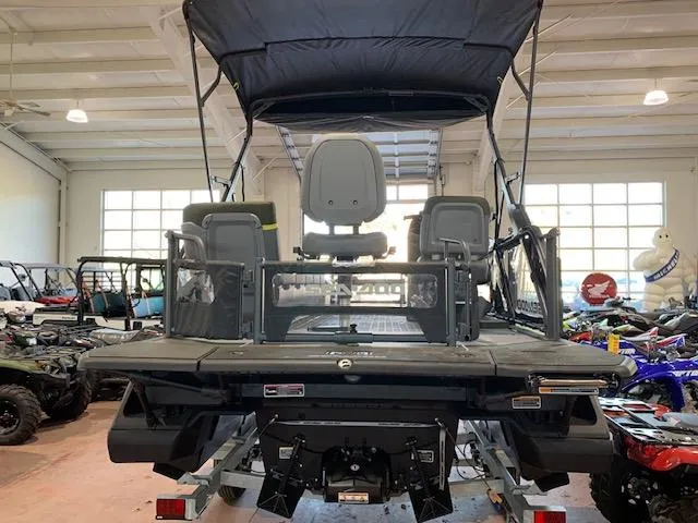 Slide: The Image of 2025 Sea-Doo Switch Fish 18 in showroom, rear view with seating and canopy. - 8