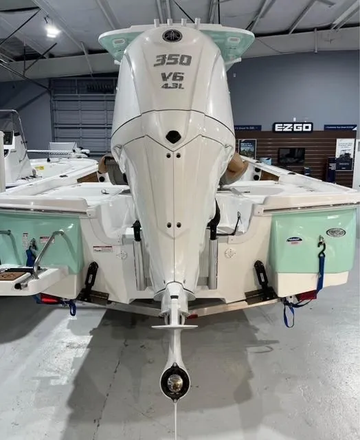 Slide: The Image of 2025 NauticStar 274 Bay boat with 350 V6 engine in a showroom. - 7