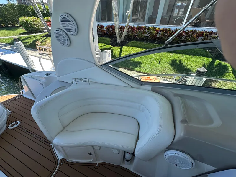 Slide: The Image of 2005 Sea Ray 320 Sundancer interior with white seating and wood deck. - 17