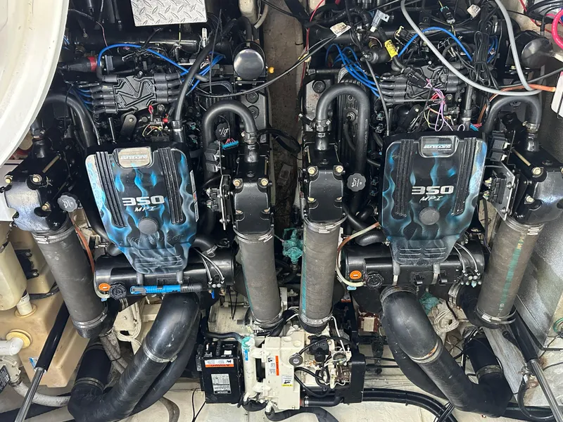 Slide: The Image of Twin engines of a 2005 Sea Ray 320 Sundancer boat, showcasing 350 horsepower each. - 19
