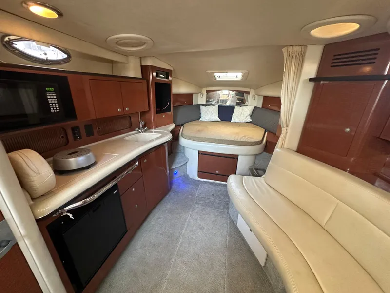 Slide: The Image of Interior of 2005 Sea Ray 320 Sundancer yacht with kitchen and seating area. - 20