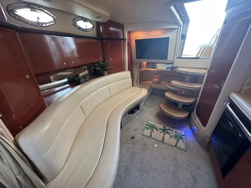 Slide: The Image of Luxurious interior of 2005 Sea Ray 320 Sundancer with curved seating and modern amenities. - 23