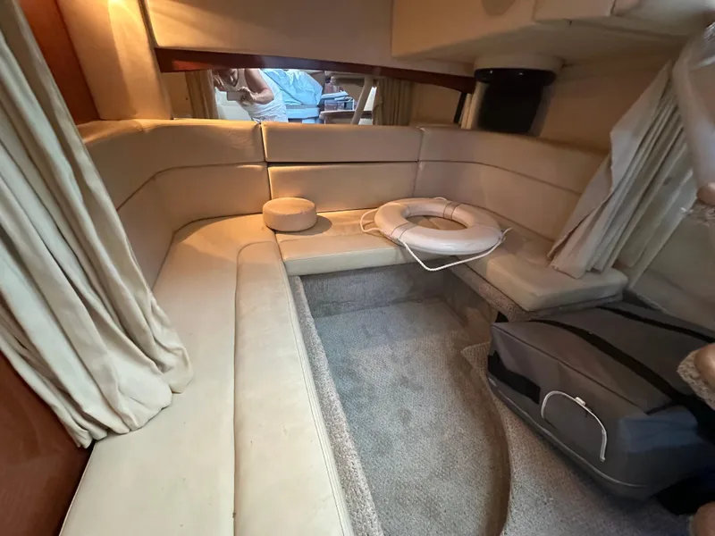 Slide: The Image of 2005 Sea Ray 320 Sundancer cabin interior with beige seating and carpet. - 24