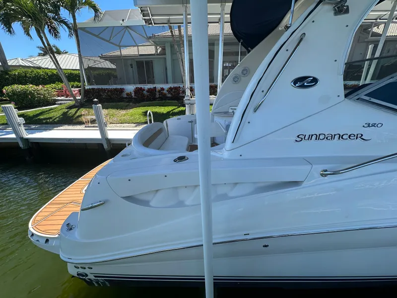 Slide: The Image of 2005 Sea Ray 320 Sundancer docked near waterfront home. - 5