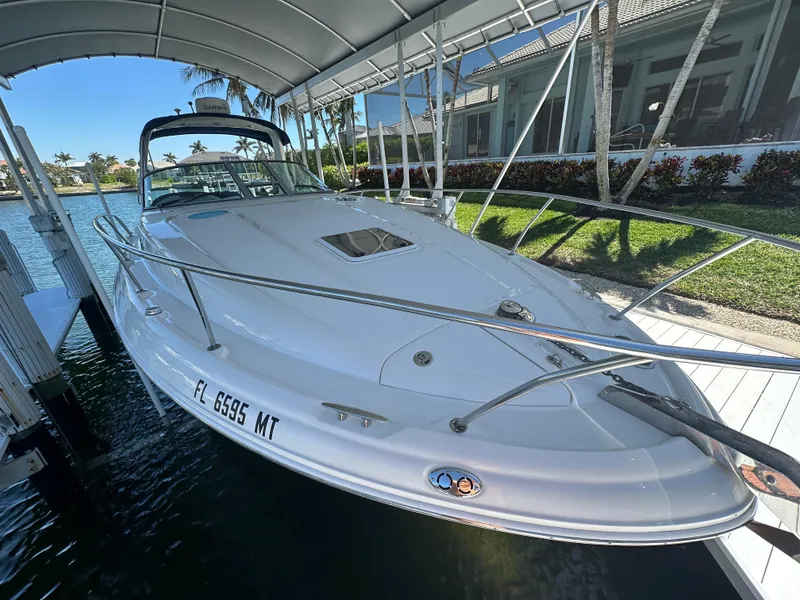 Slide: The Image of 2005 Sea Ray 320 Sundancer docked under a canopy, side view. - 7