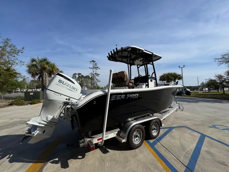 Slide: The Image of 2023 Sea Pro 219 Deep V CC boat on trailer with Suzuki engine in parking lot. - 12