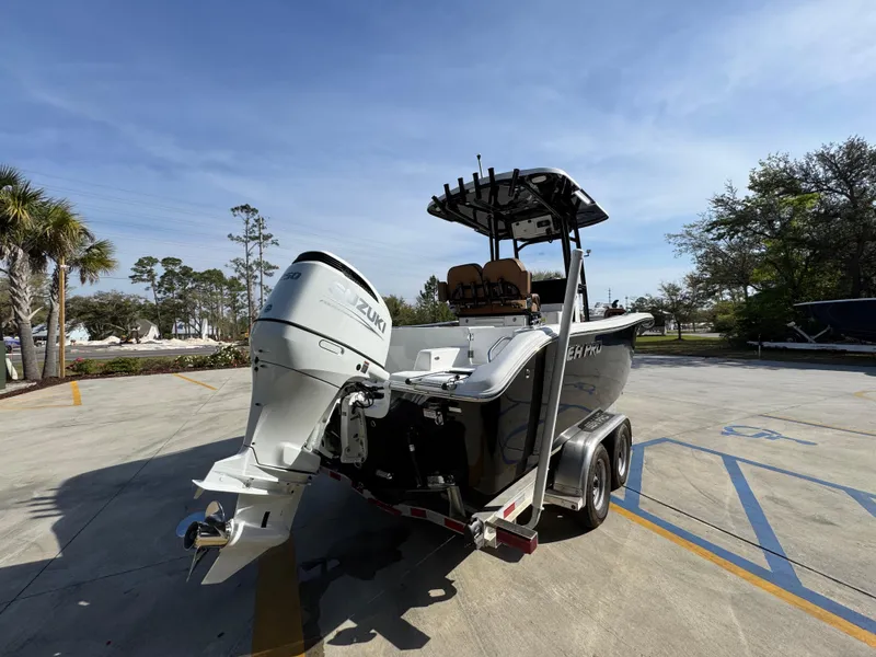 Slide: The Image of 2023 Sea Pro 219 Deep V CC boat on trailer in sunny parking lot. - 13