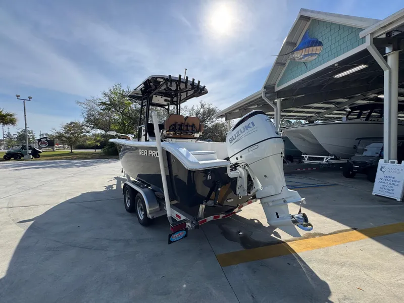 Slide: The Image of 2023 Sea Pro 219 Deep V CC boat on trailer, parked outdoors under clear sky. - 17
