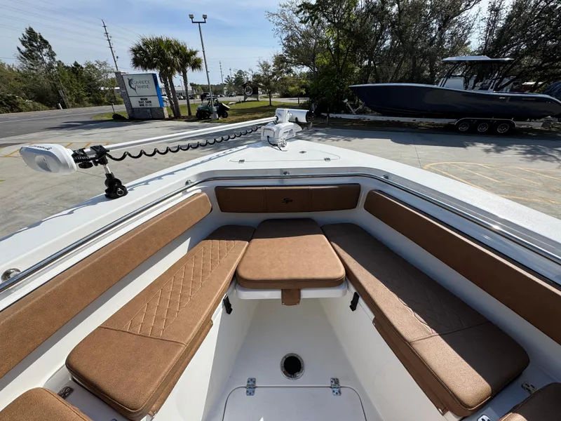Slide: The Image of 2023 Sea Pro 219 Deep V CC boat interior with cushioned seating and fishing equipment. - 19