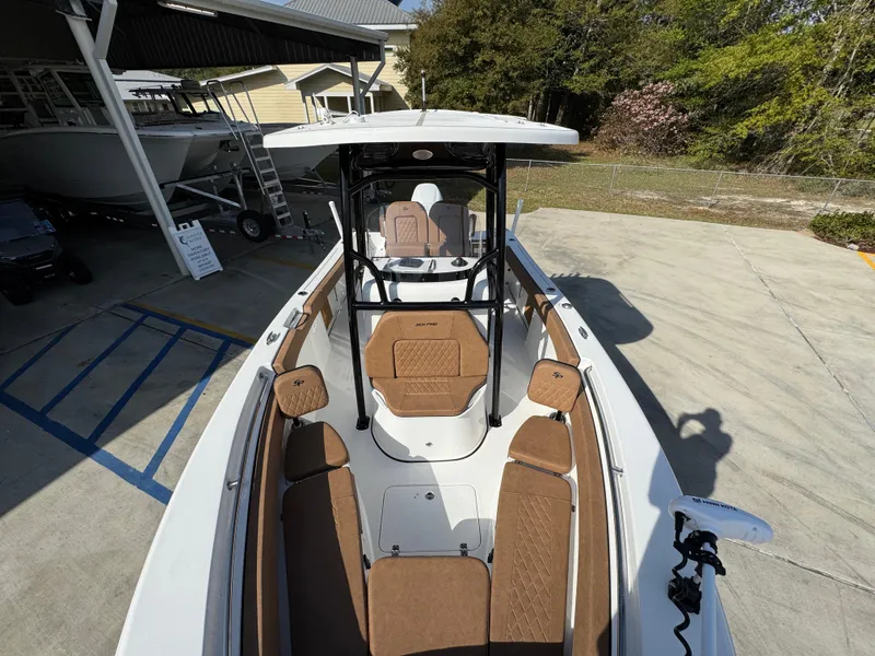 Slide: The Image of 2023 Sea Pro 219 Deep V CC boat with brown seating, docked outdoors. - 22