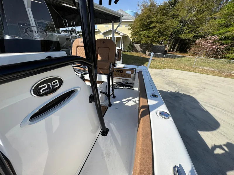Slide: The Image of 2023 Sea Pro 219 Deep V CC boat, side view, parked outdoors on concrete. - 25