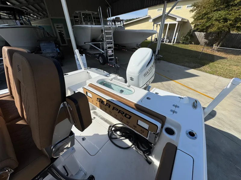 Slide: The Image of 2023 Sea Pro 219 Deep V CC boat with Suzuki outboard motor in a marina setting. - 33