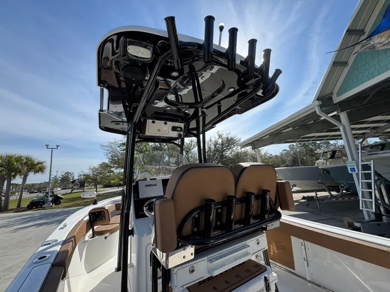 Slide: The Image of 2023 Sea Pro 219 Deep V CC boat with T-top and rod holders, docked outdoors. - 35
