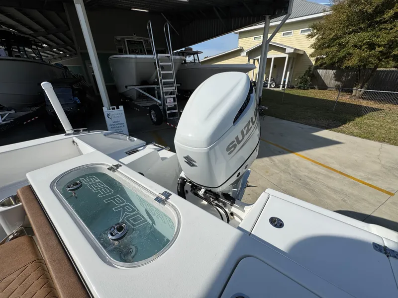 Slide: The Image of 2023 Sea Pro 219 Deep V CC boat with Suzuki outboard motor in a sunny marina. - 37