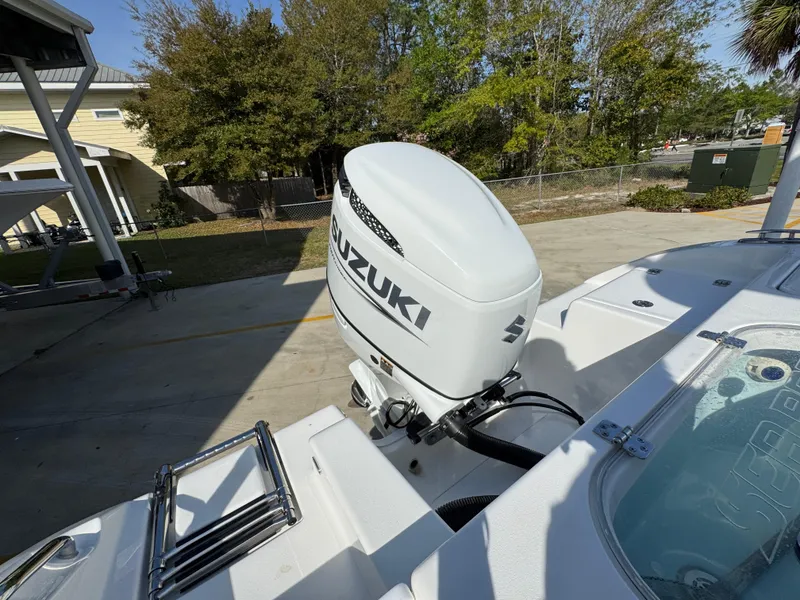 Slide: The Image of 2023 Sea Pro 219 Deep V CC with Suzuki outboard motor, docked outdoors. - 38