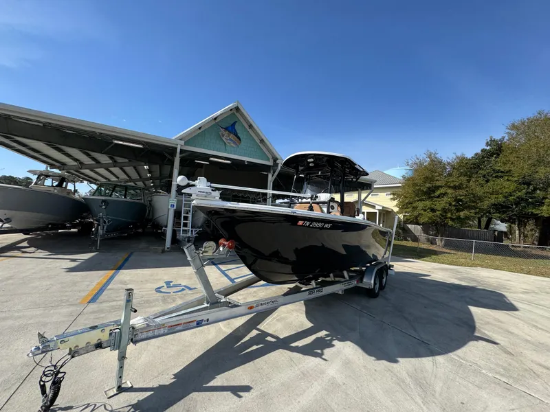 Slide: The Image of 2023 Sea Pro 219 Deep V CC boat on trailer, parked outdoors under clear blue sky. - 4