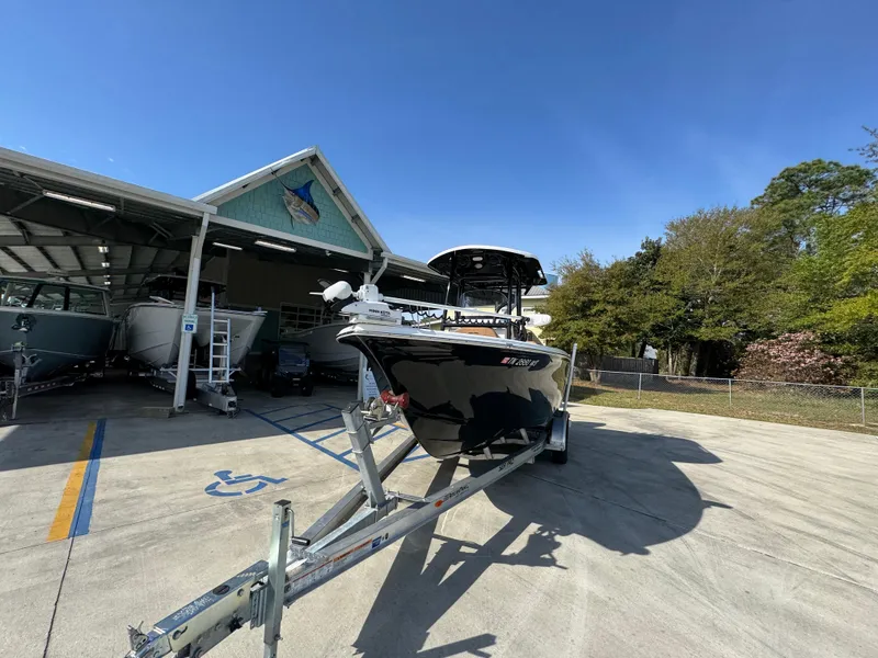 Slide: The Image of 2023 Sea Pro 219 Deep V CC boat on trailer, parked outdoors under clear blue sky. - 5