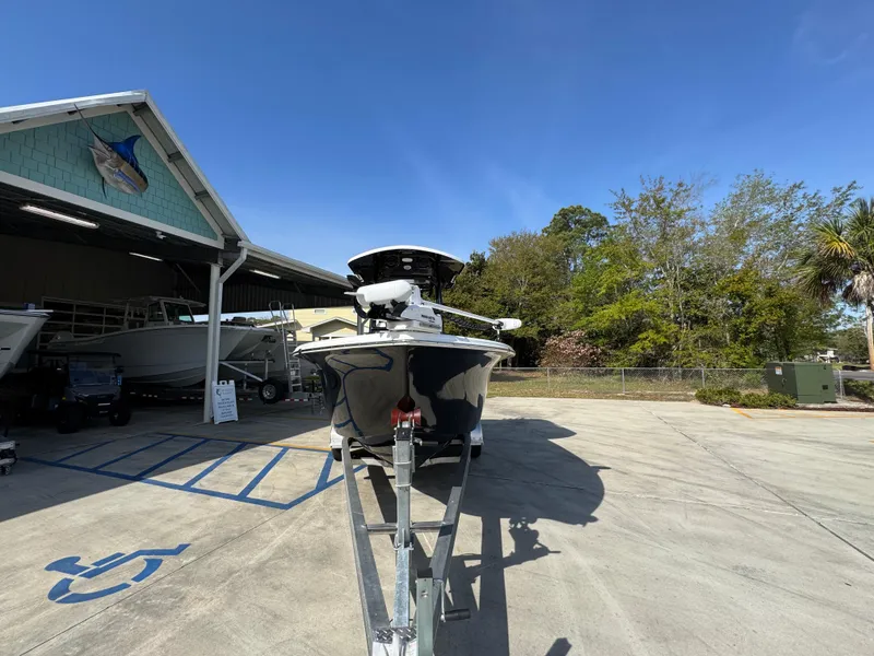 Slide: The Image of 2023 Sea Pro 219 Deep V CC boat on trailer, parked outdoors near a building. - 6