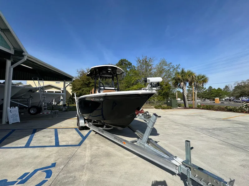 Slide: The Image of 2023 Sea Pro 219 Deep V CC boat on trailer in sunny outdoor setting. - 7