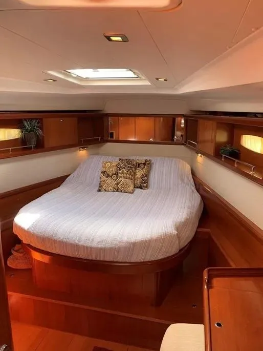 Slide: The Image of Luxurious interior of 2007 Beneteau 49' Cruiser with cozy bed and elegant wood finish. - 11