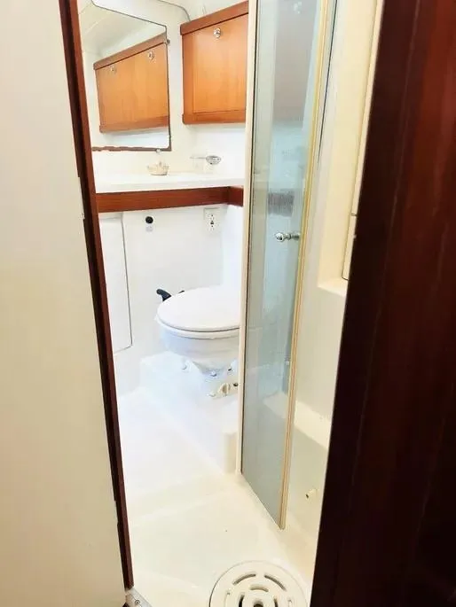 Slide: The Image of 2007 Beneteau 49' Cruiser bathroom with wooden cabinets and shower. - 14
